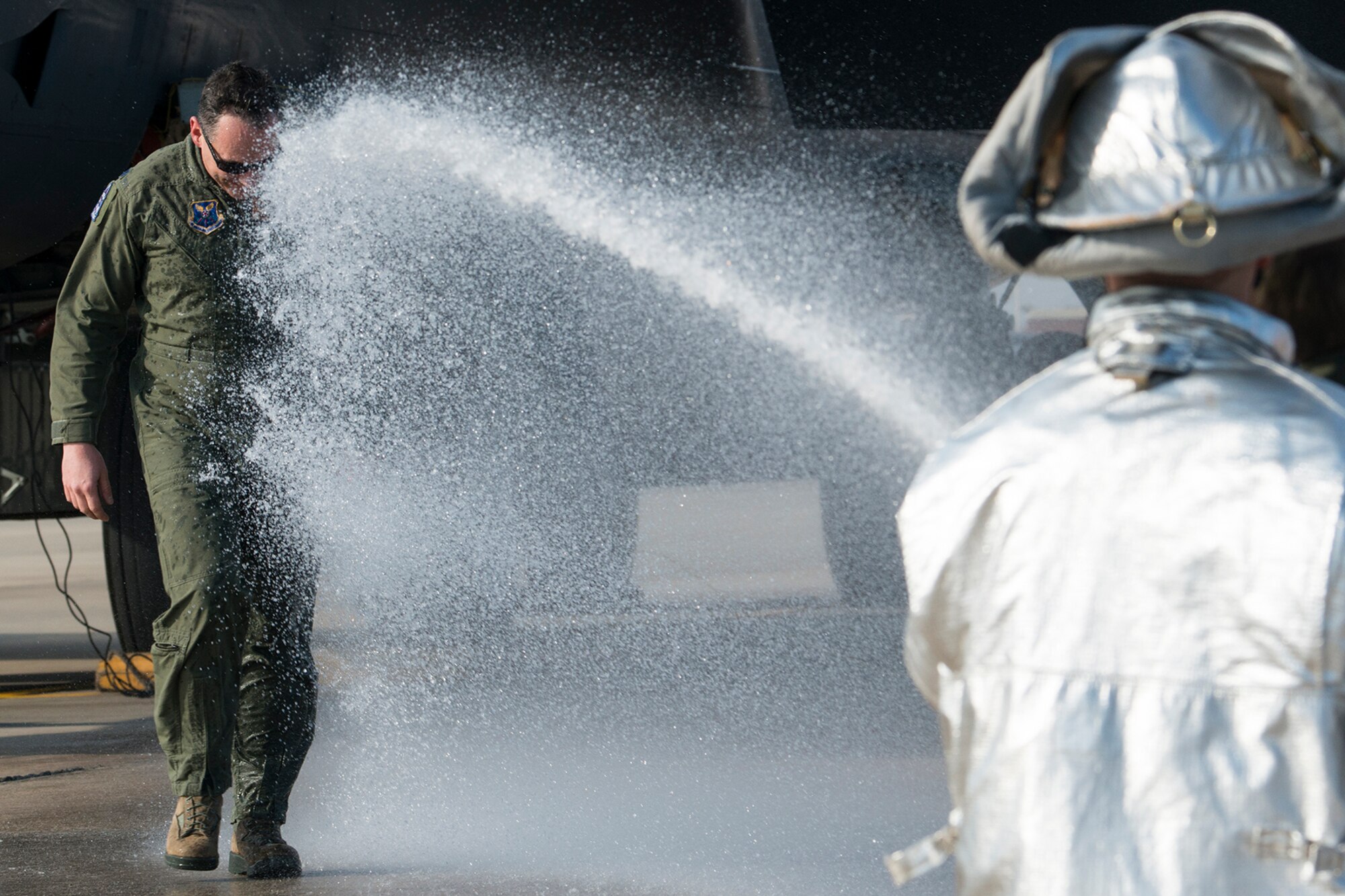U.S. Air Force Lt. Col. Bryan Patchen gets sprayed down by his family after returning from his last mission in a B-52H Stratofortress, Jan. 28, 2015, Barksdale Air Force Base, La. Patchen is an 11th Bomb Squadron instructor pilot and is retiring from the Air Force. (U.S. Air Force photo by Master Sgt. Greg Steele/Released)