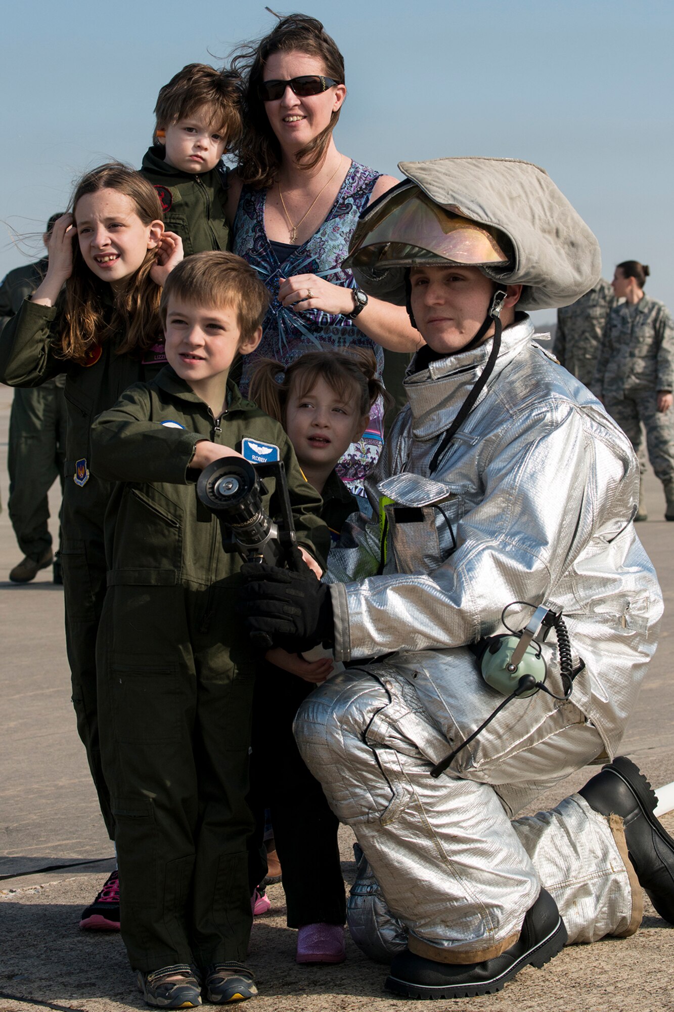 The family of U.S. Air Force Lt. Col. Bryan Patchen get ready to hose him down as he returns from his last mission in a B-52H Stratofortress, Jan. 28, 2015, Barksdale Air Force Base, La. Patchen is an 11th Bomb Squadron instructor pilot for the 307th Bomb Wing B-52 Formal Training Unit and is retiring from the Air Force. (U.S. Air Force photo by Master Sgt. Greg Steele/Released)