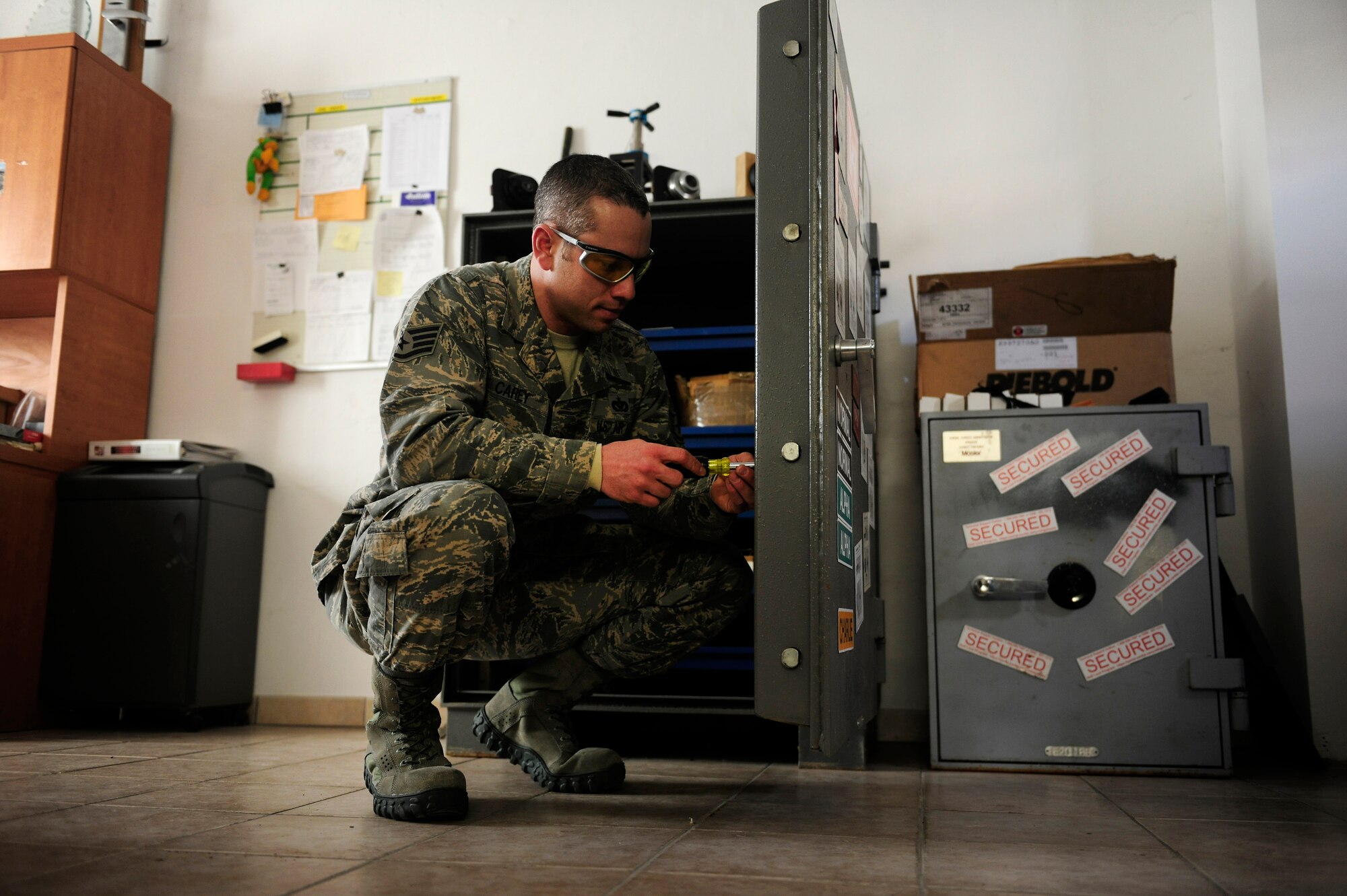 U.S. Air Force Staff Sgt. Christopher Carey, 31st Civil Engineer Squadron structural engineering craftsman, fixes a lock inside a safe, Feb. 2, 2015, at Aviano Air Base, Italy. To become a structural engineering locksmith, Airmen must complete a four-week certification course that allows them to maintain safes, vaults and other lock and key systems. (U.S. Air Force photo by Staff Sgt. Evelyn Chavez/Released)