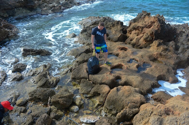 U.S. Air Force Master Sgt. Andrew Hogan, fuels manager assigned to the 52nd Expeditionary Logistics Readiness Squadron, looks for trash during a beach cleanup at Chania, Greece, Jan. 31, 2015. The Airmen participated in the cleanup during the downtime from a flying training deployment between the U.S. and Hellenic air forces at Souda Bay, Greece. (U.S. Air Force photo by Staff Sgt. Joe W. McFadden/Released) 