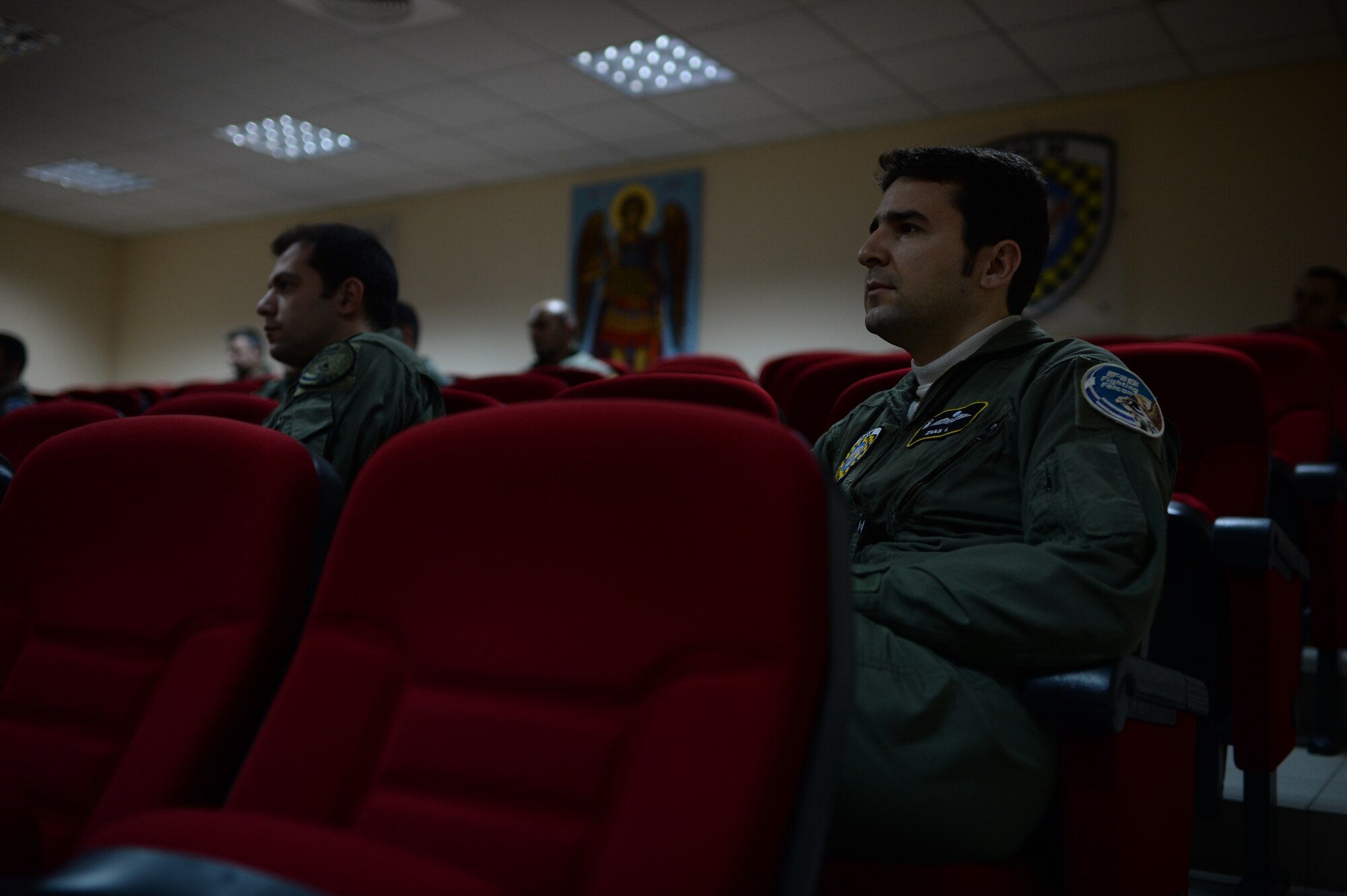 Hellenic Air Force Capt. John Zias, an F-16 Fighting Falcon fighter aircraft pilot from the 340th Fighter Squadron, listens during a briefing at his squadron at Souda Bay, Greece, Jan. 28. 2015. The training covered basic and air combat maneuvers aimed at honing the skills between the Greek and U.S. Air Forces. (U.S. Air Force photo by Staff Sgt. Joe W. McFadden/Released)