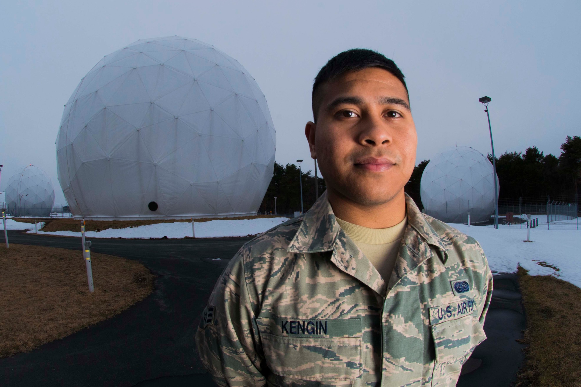 Senior Airman Philip Kengin, 35th Communications Squadron radio frequency transmission systems technician, stands in front of radar domes outside his shop Jan. 31, 2015, at Misawa Air Base, Japan. Kengin helps maintain satellite terminals that serve multiple communication purposes on the base. (U.S. Air Force photo by Staff Sgt. Derek VanHorn)