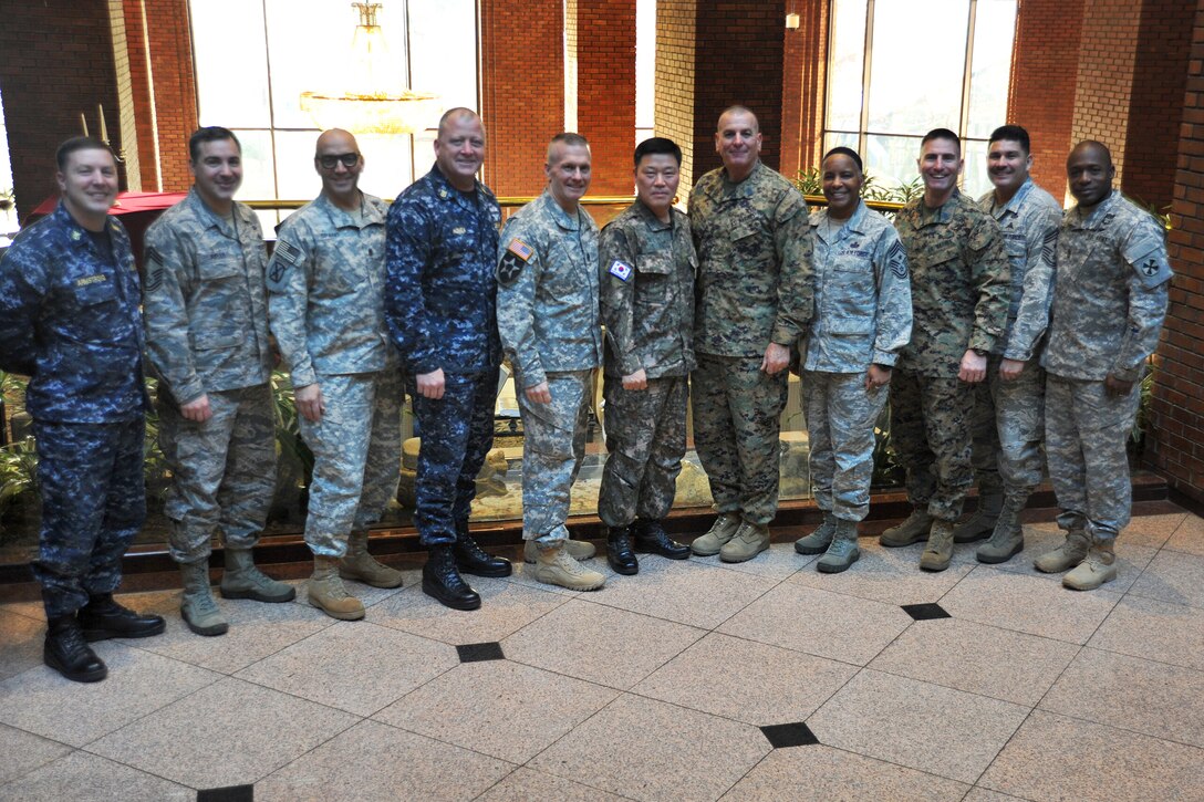 U.S. Army Command Sgt. Maj. John Troxell, center left, senior enlisted advisor to U.S. Forces Korea; U.S. Command Master Chief James Honea, fourth from left, senior enlisted advisor to U.S. Naval Forces Korea; South Korean Command Sgt. Maj. Lee Gil-ho, center; U.S. Marine Corps Sgt. Maj. Bryan Battaglia, center right, senior enlisted advisor to the chairman of the Joint Chiefs of Staff; U.S. Air Force Chief Master Sgt. Shelina E. Frey, fourth from right, senior enlisted advisor to 7th Air Force, Osan Air Base; U.S. Marine Corps Sgt. Maj. Brent Cook, third from right, senior enlisted advisor to Marine Corps Forces Korea; U.S. Army Command Sgt. Maj. Andrew Spano, third from left, senior enlisted advisor to the 2nd Infantry Division, and U.S. Army Command Sgt. Maj. Edward W. Mitchell, right, senior enlisted advisor to 8th Army, pose for a photograph after breakfast at the Dragon Hill Lodge on Yongsan Garrison in Seoul, South Korea, Feb. 3, 2015. 