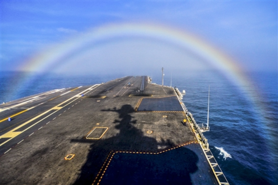 The aircraft carrier USS John C. Stennis transits through a rainbow at sea, Feb. 3, 2015. The Stennis is training to prepare for deployments. 
 