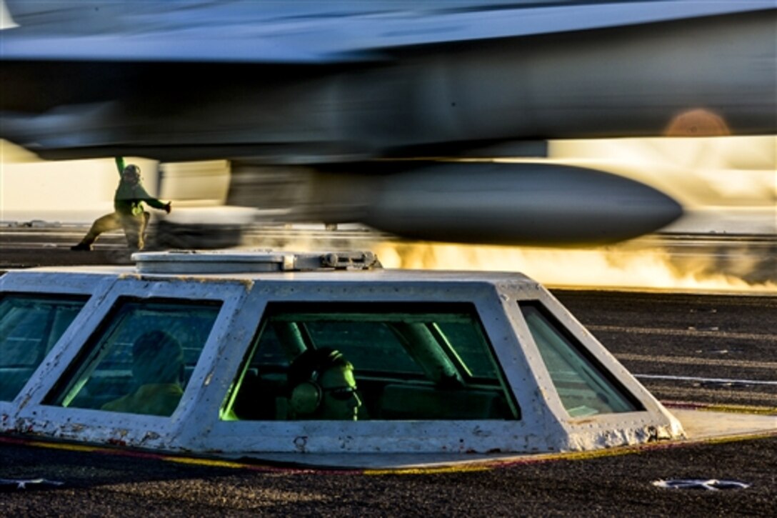 U.S. Navy Lt. Cmdr. Scott Hudson and Petty Officer 2nd Class David Stewart watch an aircraft launch from the bubble on the flight deck of the aircraft carrier USS John C. Stennis at sea, Feb. 1, 2015. The carrier is training to prepare for future deployments.  