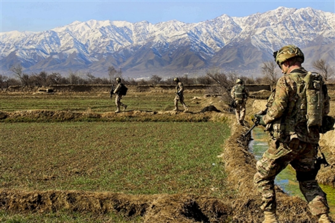 U.S. and Czech soldiers patrol along a canal and a farm field near a village in Parwan province, Afghanistan, Jan. 27, 2015. 