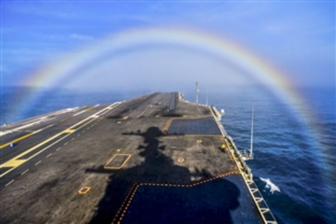The aircraft carrier USS John C. Stennis transits through a rainbow at sea, Feb. 3, 2015. The Stennis is training to prepare for future deployments. 