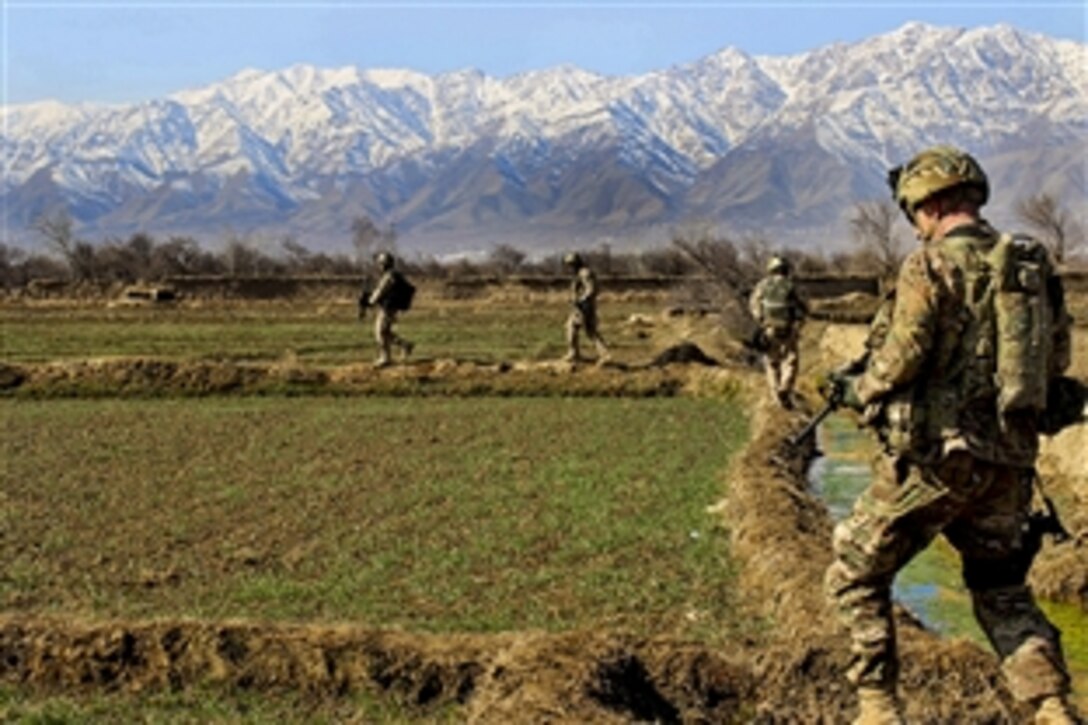 U.S. and Czech soldiers patrol along a canal and a farm field near a village in Parwan province, Afghanistan, Jan. 27, 2015. 