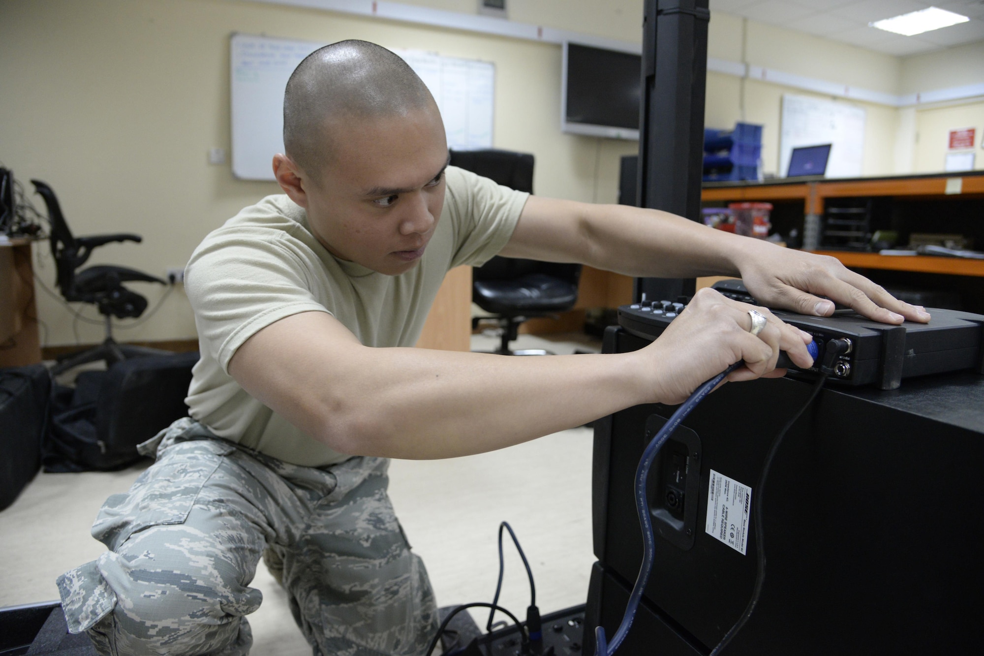 Airman 1st Class Ryan, radio frequency transmission technician, sets up a sound system at an undisclosed location in Southwest Asia Jan 28, 2015. Airmen in the radio frequency transmission shop are commonly referred to as ground radio. Ryan is currently deployed from Nellis Air Force Base, Nev., and is a native of Las Vegas, Nev. (U.S. Air Force photo/Tech. Sgt. Marie Brown)