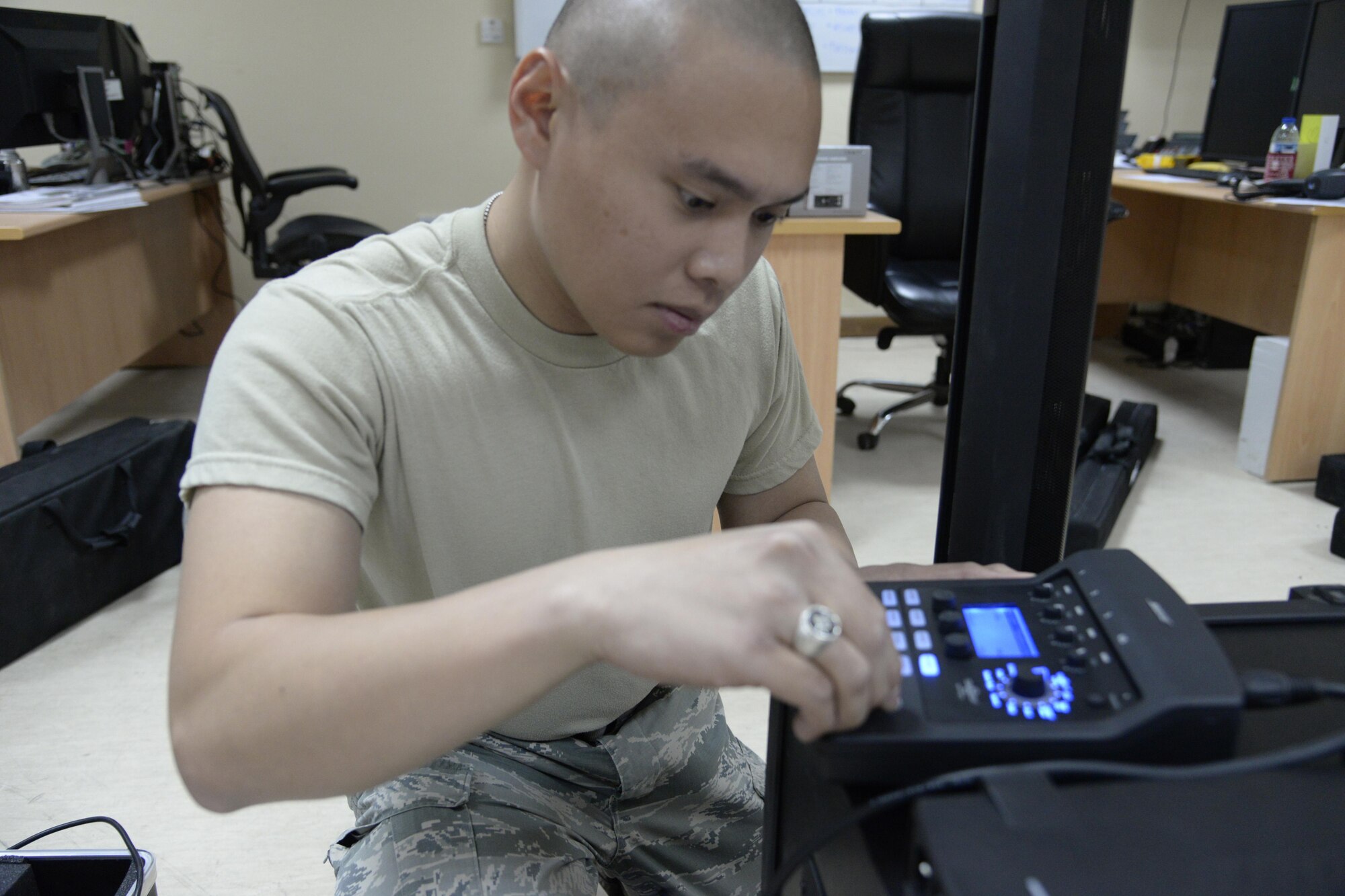 Airman 1st Class Ryan, radio frequency transmission technician, sets up a sound system at an undisclosed location in Southwest Asia Jan 28, 2015. Anytime there is an all call, award ceremony or other special event that requires sound the RF transmission shop is there to work. Ryan is currently deployed from Nellis Air Force Base, Nev., and is a native of Las Vegas, Nev. (U.S. Air Force photo/Tech. Sgt. Marie Brown)