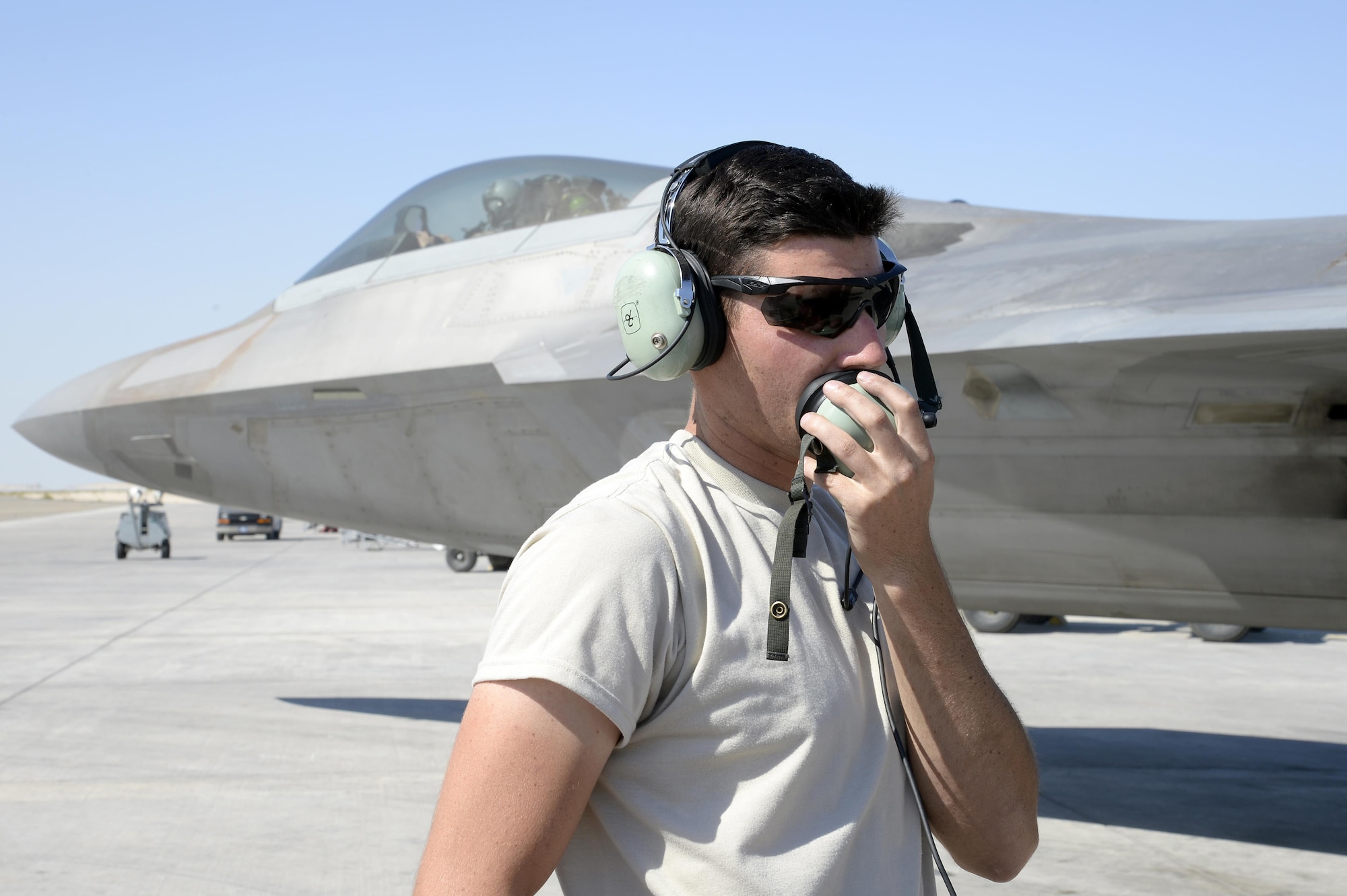 Airman 1st Class Kyle, crew chief, talks to the pilot of an F-22 Raptor prior to taxi at an undisclosed location in Southwest Asia Jan. 26, 2015. The F-22 Raptor, which became operational in 2005, is the Air Force's newest fighter aircraft and cannot be matched by any known or projected fighter aircraft. Kyle is currently deployed from Tyndall Air Force Base, Fla., and is a native of Eagle River, Alaska. (U.S. Air Force/Tech. Sgt. Marie Brown)
