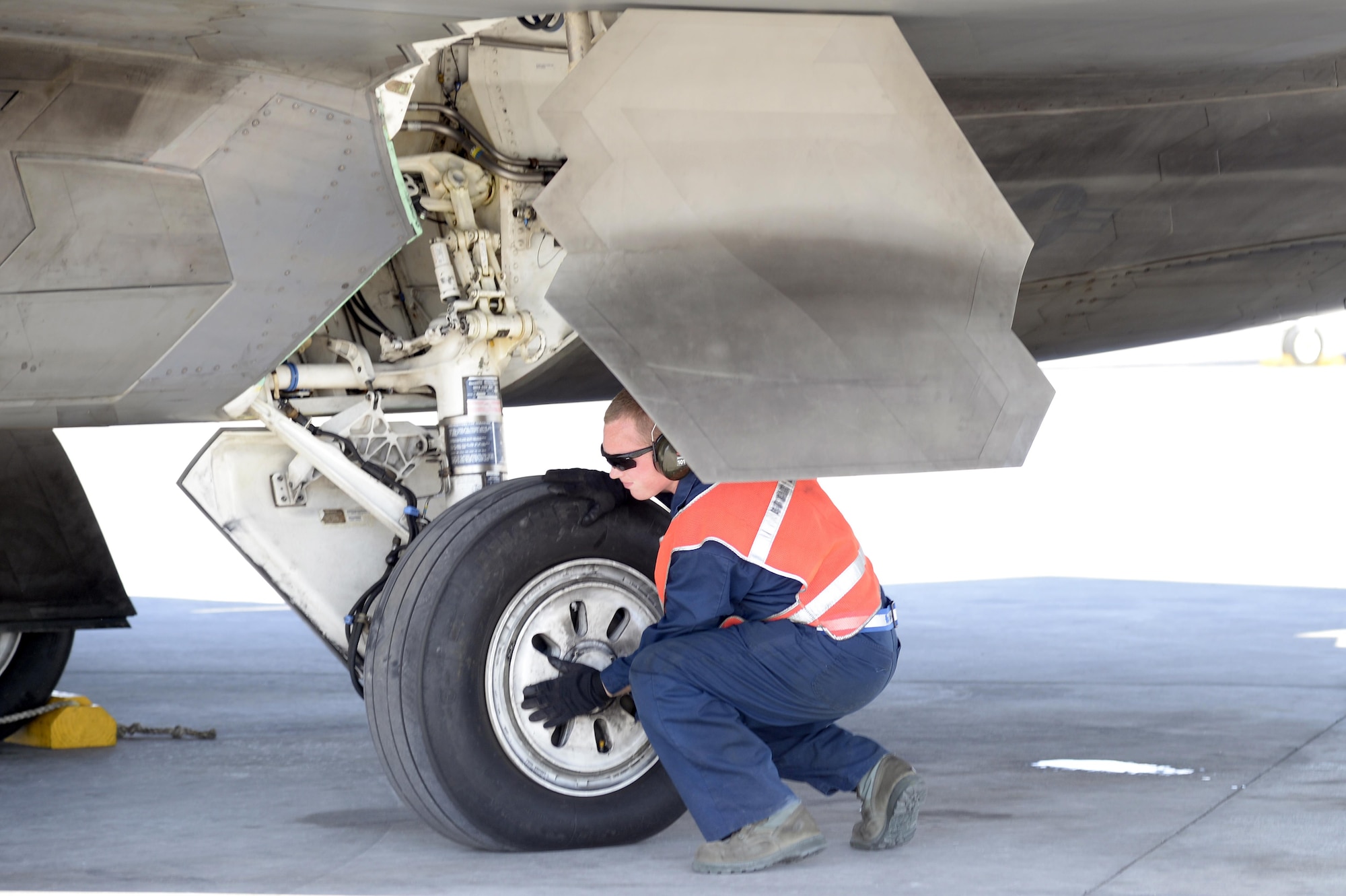 Airman 1st Class David, crew chief, performs a final inspection of an F-22 Raptor prior to taxi for take-off at an undisclosed location in Southwest Asia Jan. 26, 2015.  Whether it is day-to-day servicing or avionics maintenance on the world’s most advanced and lethal fighter aircraft, Airmen within the Raptor Aircraft Maintenance Unit are vital to ensuring the F-22 Raptor remains unmatched in the skies. David is currently deployed from Tyndall Air Force Base, Fla., and is a native of Richards, Missouri. (U.S. Air Force/Tech. Sgt. Marie Brown)