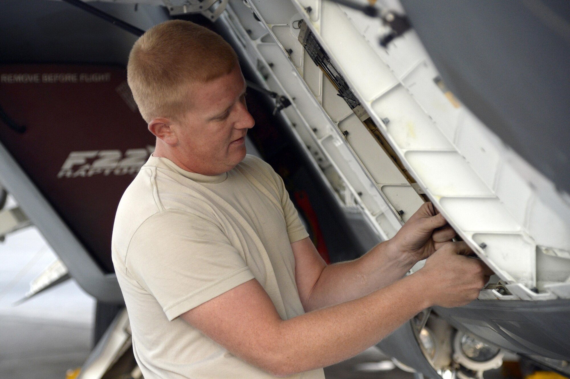 Staff Sgt. James, avionics craftsman, troubleshoots a communications, navigation and identification system on an F-22 Raptor at an undisclosed location in Southwest Asia Jan. 26, 2015. The F-22's CNI 'system' is a collection of communication, navigation and identification functions, employing a common integrated processor for signal and data processing resources. James is currently deployed from Tyndall Air Force Base, Fla., and is a native of Frackville, Pa. (U.S. Air Force/Tech. Sgt. Marie Brown)
