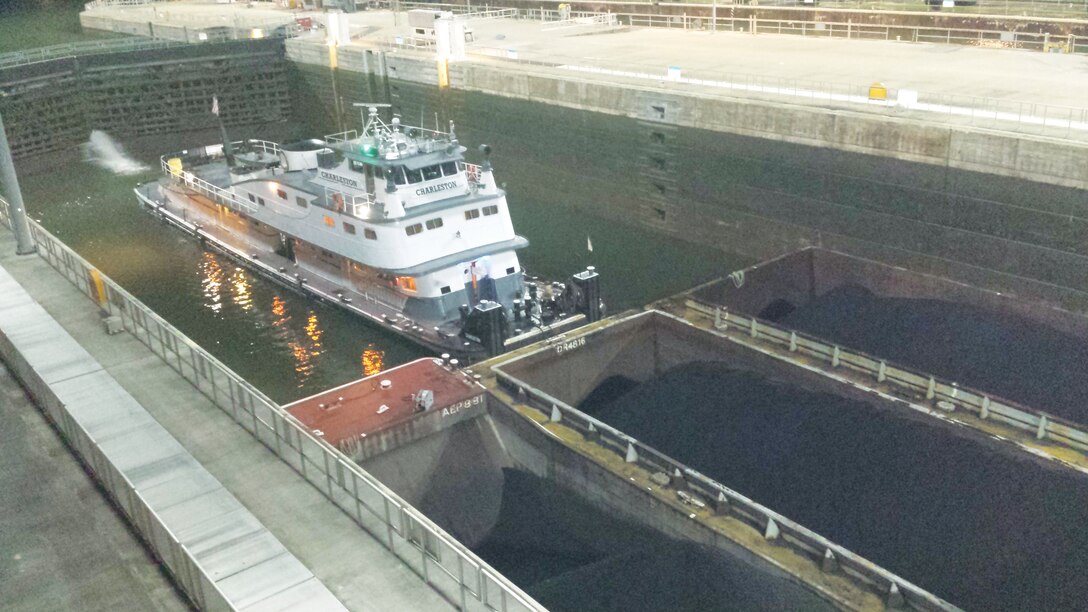 A tow navigates through the Marmet Locks and Dam after the installation of new lighting.