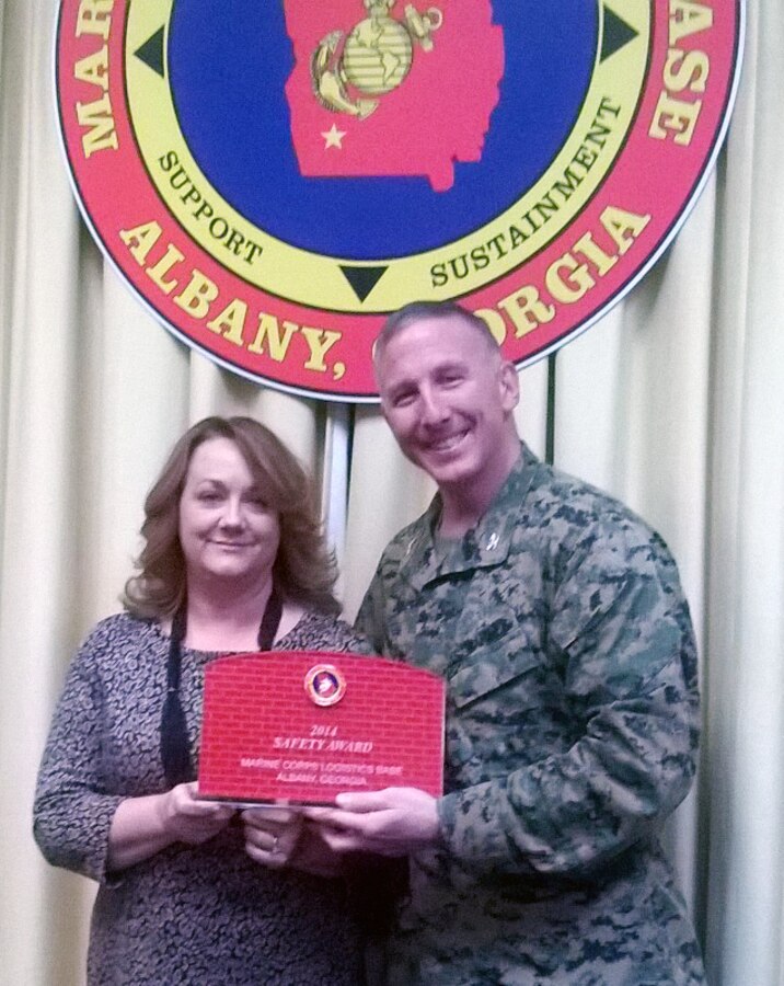 Lori Farr, director, Communication and Information Systems Division, Marine Corps Logistics Base Albany (left), recently receives the 2014 Division Safety Award from Col. Donald J. Davis, commanding officer, MCLB Albany.