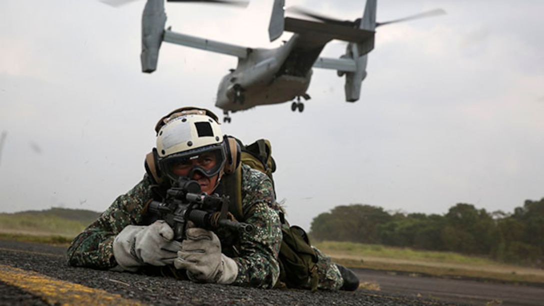 A Philippine Marine posts security after fast-roping out of an MV-22B Osprey tiltrotor aircraft Jan. 22 at Basa Air Field. Fast-roping is just one of the multiple training events conducted during Aviation Assault Support Exercise 15.1. AASE expands and promotes cooperative training opportunities with the Armed Forces of the Philippines to enhance core skill proficiency and to increase operational readiness. The Philippine Marines are with various units and the U.S. Marines are with 3rd Battalion, 3rd Marine Regiment currently assigned to 3rd Marine Division, III Marine Expeditionary Force under the unit deployment program. (U.S. Marine Corps photo by Lance Cpl. Ryan C. Mains/Released).
