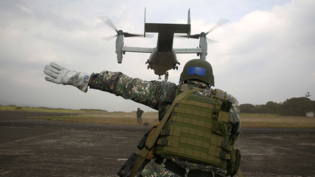 A Philippine Marine directs Philippine and U.S. Marines after they fast-rope out of a MV-22B Osprey tiltrotor aircraft during a fast-rope exercise Jan. 22 at Basa Air Field. Fast-roping is just one of the multiple training events conducted during Aviation Assault Support Exercise 15.1. AASE expands and promotes cooperative training opportunities with the Armed Forces of the Philippines to enhance core skill proficiency and to increase operational readiness. The Philippine Marines are with various units and the U.S. Marines are with 3rd Battalion, 3rd Marine Regiment currently assigned to 3rd Marine Division, III Marine Expeditionary Force under the unit deployment program.  (U.S. Marine Corps photo by Lance Cpl. Ryan C. Mains/Released).