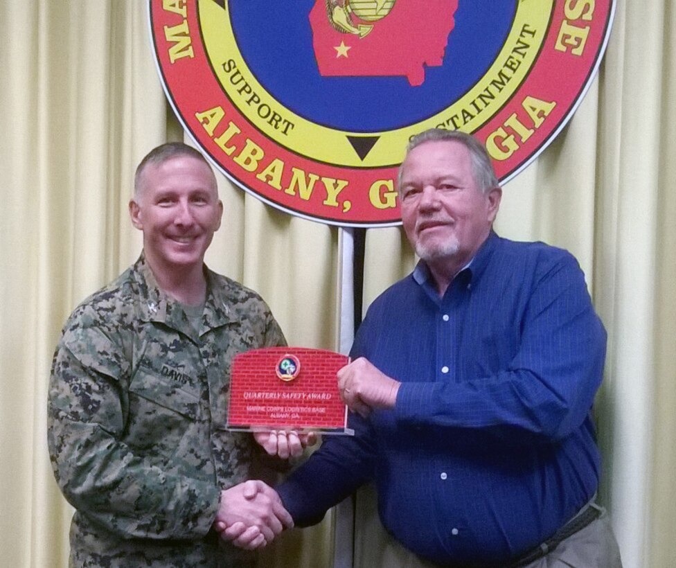 Bill McNulty, director, Public Safety Division, Marine Corps Logistics Base Albany, (left) receives the Quarterly Division Safety Award, Fourth Quarter, calendar year 2014 from Col. Donald J. Davis, commanding officer, MCLB Albany.