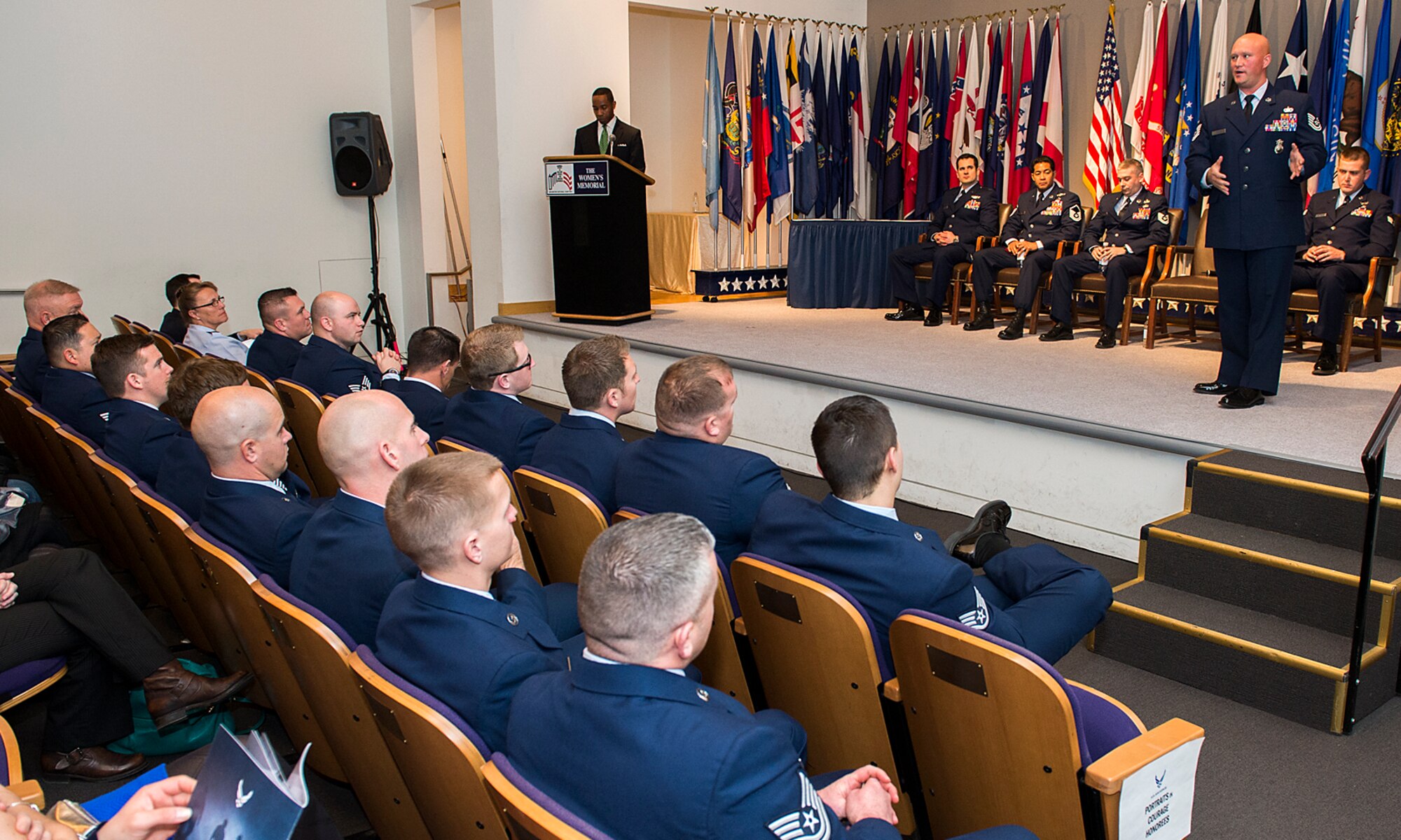 Air Force military working dog handler Tech. Sgt. Daniel Wilson, an honoree from the Air Force's ninth volume of Portraits in Courage, tells his story to a group of Air Force civic leaders from around the country, during a luncheon Feb. 4, 2015, Arlington, Va. Portraits in courage is an Air Force program highlighting Airmen for their honor, valor, devotion and selfless sacrifice in the face of extreme danger to themselves and others. (U.S. Air Force photo/Jim Varhegyi)