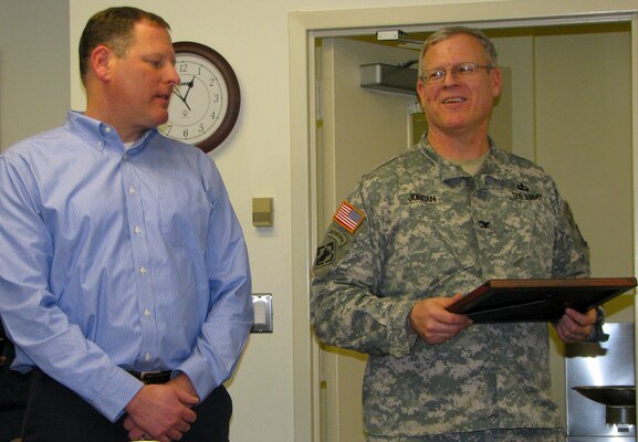 Project Manager Wayne Davis is presented with the January Hero of the Month award from Col. Jordan, Baltimore District commander, Jan. 15, 2015. Davis was nominated for his tireless efforts and amazing customer support to the Military Project Management Section and for his work on a complex multi-million dollar contract at Fort Drum, N.Y. (U.S. Army Photo by Clem Gaines)