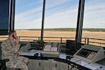 Sgt. Jeffrey Baehr, a Louisiana National Guard air traffic controller, observes a plane taking off from the newly constructed air traffic control tower at Hammond Northshore Regional Airport, Dec. 17, 2014. The National Guard's 244th Air Assault Helicopter Battalion and 204th Theater Air Operation Group are based at the airport. Army and Air National Guardsmen staff the control tower, enhancing safety at the airport and allowing a wider range of civilian and military aircraft to use the facility.