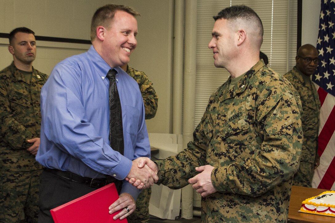 Lt. Col. Brian R. Taylor, commanding officer, Marine Corps Institute, presents awards during the Marine Corps Institute 95th birthday celebration at the Washington Navy Yard, on Feb. 4, 2015. (U.S. Marine Corps photo by Staff Sgt. Mallory S. VanderSchans/Released)