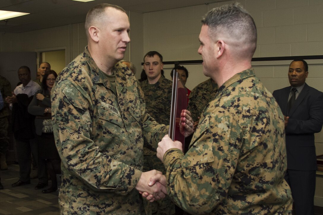 Lt. Col. Brian R. Taylor, commanding officer, Marine Corps Institute, presents awards during the Marine Corps Institute 95th birthday celebration at the Washington Navy Yard, on Feb. 4, 2015. (U.S. Marine Corps photo by Staff Sgt. Mallory S. VanderSchans/Released)