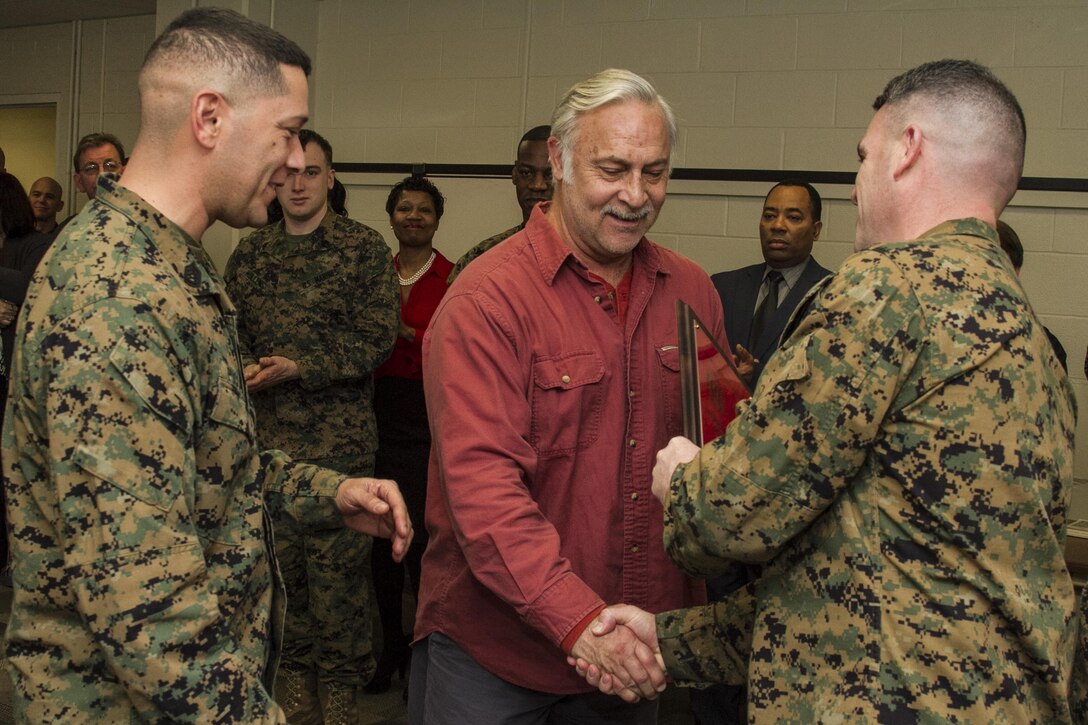 Lt. Col. Brian R. Taylor, commanding officer, Marine Corps Institute, presents awards during the Marine Corps Institute 95th birthday celebration at the Washington Navy Yard, on Feb. 4, 2015. (U.S. Marine Corps photo by Staff Sgt. Mallory S. VanderSchans/Released)