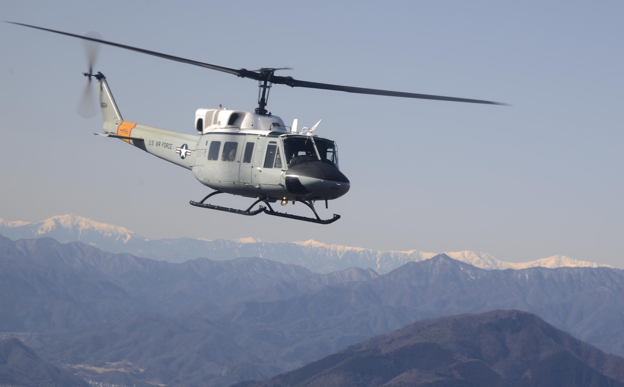 A UH-1N Iroquois helicopter flies over Japanese mountaintops on its way back to Yokota Air Base, Japan, Jan. 29, 2015, after completing a bilateral training mission. U.S. Airmen trained with Japan Ground Self-Defense Force members during the mission. (U.S. Air Force photo/Senior Airman Michael Washburn) 