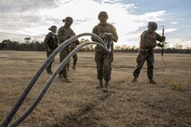Landing support specialists with Combat Logistics Battalion 2, Combat Logistics Regiment 2, 2nd Marine Logistics Group, prepare an 8,500 pound beam set to be attached to a CH-53 Super Stallion helicopter with Marine Heavy Helicopter Training Squadron 302, Marine Aircraft Group 29, 2nd Marine Aircraft Wing, during helicopter support team operations aboard Camp Lejeune, N.C., Jan. 29, 2015. Marines would practice and rotate positions to become familiar with each portion of a HST. This is an annual training requirement for landing support specialist Marines. (U.S. Marine Corps photo by Cpl. James R. Smith/Released)