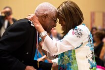 The late Pearlie Harvey, right, congratulates her husband, Ret. Lt. Col. James Harvey, left, at the Gala Dinner for the Tuskegee Airmen 40th National Convention, August 6, 2011, at the Gaylord National Hotel, Md. Colonel Harvey received the Noel F. Parrish Award, the Tuskegee Airmen Inc., highest of honor. This award recognizes outstanding endeavors to enhance access to knowledge, skills, and opportunities.  