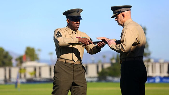 Sergeant Maj. Ronald Green returns the noncommissioned officer’s sword to Lt. Gen. David H. Berger, I Marine Expeditionary Force commanding general, signifying the end of his tour as the I MEF sergeant major, during a relief and appointment ceremony aboard Marine Corps Base Camp Pendleton, Calif., Feb. 4, 2015. During the ceremony, the Marines bid farewell to Green as he prepares to assume his new post as the Sergeant Major of the Marine Corps, and welcomed Sgt. Maj. Bradley Kasal as the new I MEF sergeant major. (U.S. Marine Corps photo by Cpl. Christopher J. Moore/Released)
