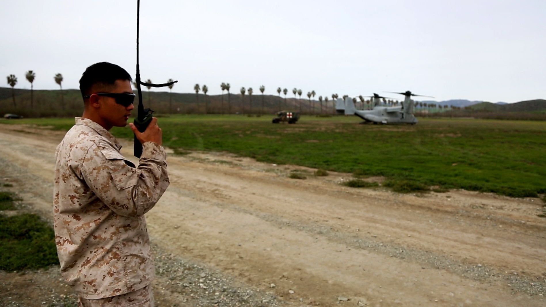 A data network specialist from Headquarters Regiment, 1st Marine Logistics Group, communicates with an MV-22 Osprey pilot during an en-route care exercise aboard Camp Pendleton, Calif., Jan. 28, 2015. During the four-day exercise, corpsmen trained to prepare a Special-Purpose Marine Air-Ground Task Force group that is going to forward deploy later this year. The more than 40 corpsmen set up a shock trauma platoon facility, or mobile emergency room, to treat simulated casualties. The casualties were stabilized in the STP and then flown out via aircraft. (U.S. Marine Corps photo by Sgt. Laura Gauna/Released)