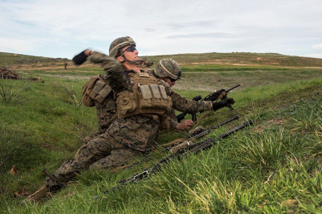 U.S. Marine Lance Cpl. John Przybylo throws a simulated grenade during squad tactics and maneuver training aboard Camp Pendleton, Calif., Jan. 26, 2015. Przybylo is a team leader with Kilo Company, Battalion Landing Team 3rd Battalion, 1st Marine Regiment, 15th Marine Expeditionary Unit. As the ground combat element for the 15th MEU, BLT 3/1 is preparing for their upcoming deployment by enhancing their combat skills and learning to work as a cohesive unit. (U.S. Marine Corps Photo by Sgt. Emmanuel Ramos/Released)