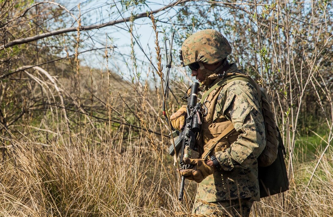 U.S. Marine Cpl. Jorge Castro patrols with his squad during squad tactics and maneuver training aboard Camp Pendleton, Calif., Jan. 27, 2015. Castro is a section leader with Kilo Company, Battalion Landing Team 3rd Battalion, 1st Marine Regiment, 15th Marine Expeditionary Unit. As the ground combat element for the 15th MEU, BLT 3/1 is preparing for their upcoming deployment by enhancing their combat skills and learning to work as a cohesive unit. (U.S. Marine Corps Photo by Sgt. Emmanuel Ramos/Released)