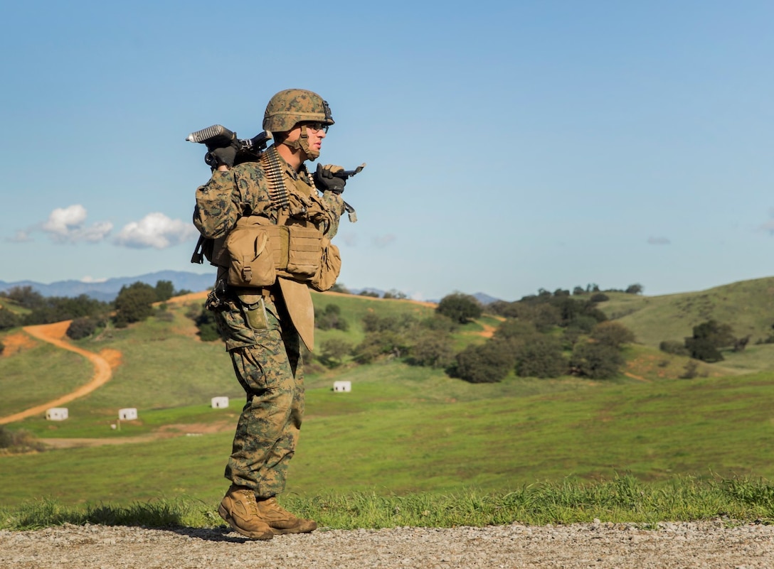 U.S. Marine Lance Cpl. Alexander Basco patrols with his squad during squad tactics and maneuver training aboard Camp Pendleton, Calif., Jan. 27, 2015. Basco is a machine gunner with Kilo Company, Battalion Landing Team 3rd Battalion, 1st Marine Regiment, 15th Marine Expeditionary Unit. As the ground combat element for the 15th MEU, BLT 3/1 is preparing for their upcoming deployment by enhancing their combat skills and learning to work as a cohesive unit. (U.S. Marine Corps Photo by Sgt. Emmanuel Ramos/Released)