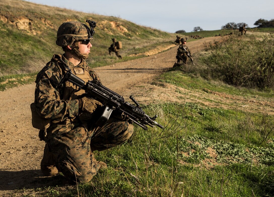 U.S. Marine Lance Cpl. Brandon Swindell provides security during squad tactics and maneuver training aboard Camp Pendleton, Calif., Jan. 28, 2015. Swindell is an automatic rifleman with Kilo Company, Battalion Landing Team 3rd Battalion, 1st Marine Regiment, 15th Marine Expeditionary Unit. As the ground combat element for the 15th MEU, BLT 3/1 is preparing for their upcoming deployment by enhancing their combat skills and learning to work as a cohesive unit. (U.S. Marine Corps Photo by Sgt. Emmanuel Ramos/Released)