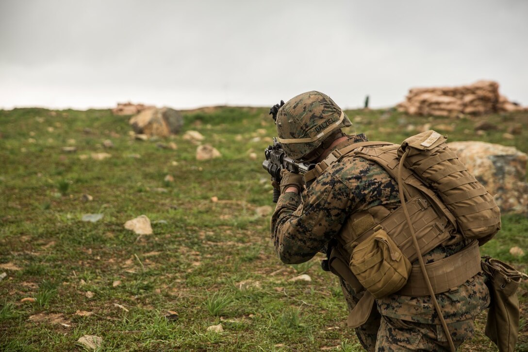 U.S. Marine Lance Cpl. Alexander Dalziel engages targets during squad tactics and maneuver training aboard Camp Pendleton, Calif., Jan. 29, 2015. Daziel is a team leader with Kilo Company, Battalion Landing Team 3rd Battalion, 1st Marine Regiment, 15th Marine Expeditionary Unit. As the ground combat element for the 15th MEU, BLT 3/1 is preparing for their upcoming deployment by enhancing their combat skills and learning to work as a cohesive unit. (U.S. Marine Corps Photo by Sgt. Emmanuel Ramos/Released)