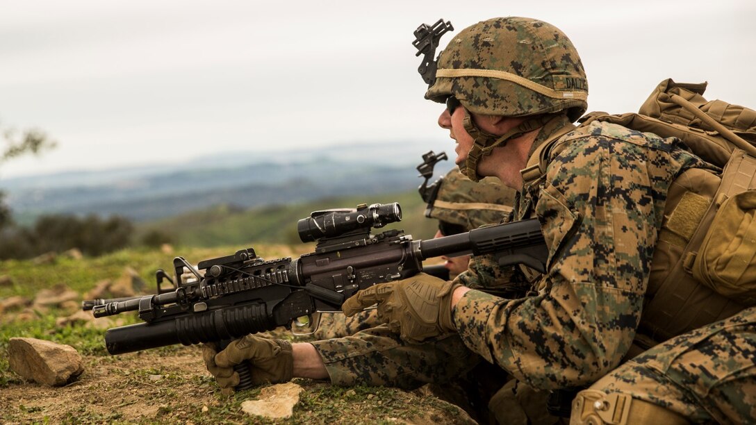 U.S. Marine Lance Cpl. Alexander Dalziel asses enemy threat during squad tactics and maneuver training aboard Camp Pendleton, Calif., Jan. 29, 2015. Dalziel is a team leader with Kilo Company, Battalion Landing Team 3rd Battalion, 1st Marine Regiment, 15th Marine Expeditionary Unit. As the ground combat element for the 15th MEU, BLT 3/1 is preparing for their upcoming deployment by enhancing their combat skills and learning to work as a cohesive unit. (U.S. Marine Corps Photo by Sgt. Emmanuel Ramos/Released)
