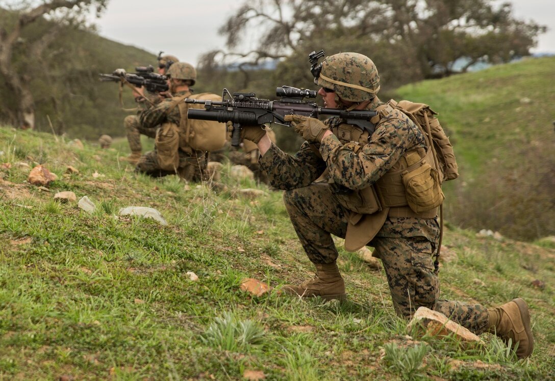 U.S. Marine Lance Cpl. Alexander Dalziel engages targets during squad tactics and maneuver training aboard Camp Pendleton, Calif., Jan. 29, 2015. Daziel is a team leader with Kilo Company, Battalion Landing Team 3rd Battalion, 1st Marine Regiment, 15th Marine Expeditionary Unit. As the ground combat element for the 15th MEU, BLT 3/1 is preparing for their upcoming deployment by enhancing their combat skills and learning to work as a cohesive unit. (U.S. Marine Corps Photo by Sgt. Emmanuel Ramos/Released)
