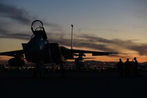 Three maintainers from the 748th Aircraft Maintenance Squadron, Royal Air Force Lakenheath, England, work near an F-15C Eagle at dusk during Red Flag 15-1 at Nellis Air Force Base, Nev., Feb. 2, 2015. Maintainers are responsible for overseeing the day-to-day maintenance of aircraft, including diagnosing malfunctions and replacing components, and conducting various inspections to ensure the aircraft is functioning properly. (U.S. Air Force photo by Tech. Sgt. Eric Burks/Released)
