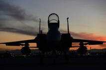 An F-15C Eagle assigned to the 493rd Fighter Squadron, Royal Air Force Lakenheath, England, sits on the flightline at dusk during Red Flag 15-1 at Nellis Air Force Base, Nev., Feb. 2, 2015. Flying units from around the world come to Nellis AFB to participate in Red Flag exercises, which are held three to four times per year. (U.S. Air Force photo by Tech. Sgt. Eric Burks/Released)