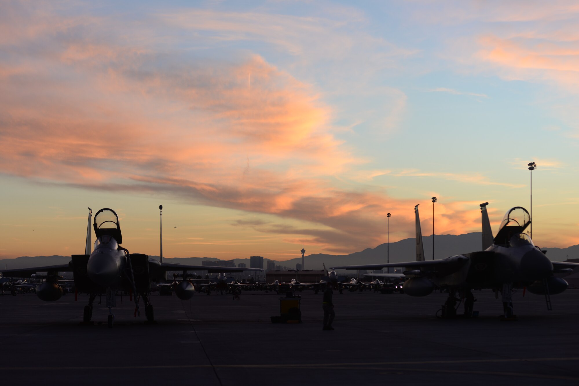 Two F-15C Eagles assigned to the 493rd Fighter Squadron, Royal Air Force Lakenheath, England, sit on the flightline at dusk during Red Flag 15-1 at Nellis Air Force Base, Nev., Feb. 2, 2015. Red Flag is a realistic combat exercise involving U.S. and allied air forces conducting training operations on the 15,000 square mile Nevada Test and Training Range. (U.S. Air Force photo by Tech. Sgt. Eric Burks/Released)