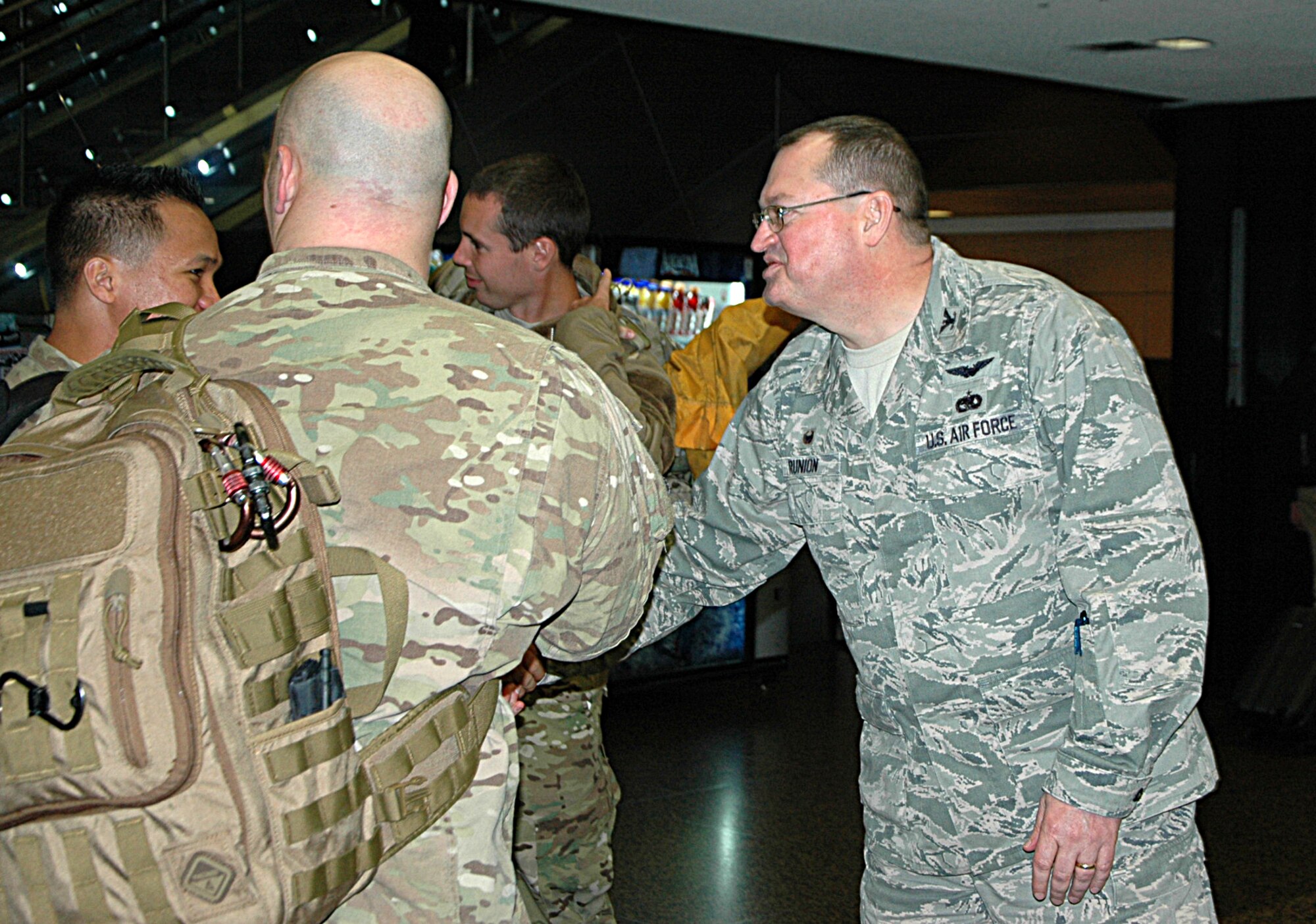At the Seattle-Tacoma Airport Feb. 5, Col. Bryan Runion, 446th Mission Support Group commander, welcomes home eight Citizen Airmen returning from a deployment to Senegal in support of Operation United Assistance. (U.S. Air Force Reserve photo by Sandra Pishner)
