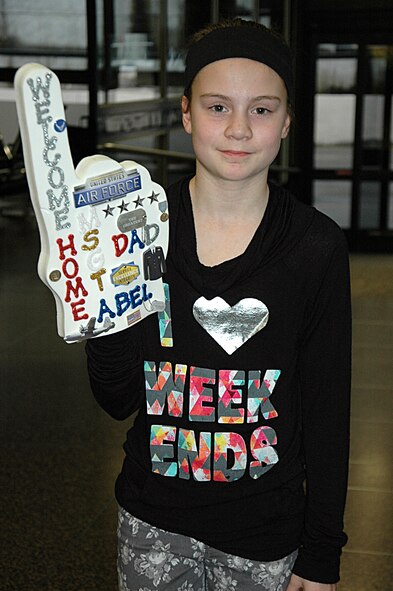 At the Seattle-Tacoma Airport Feb. 5, Hadley Abel, age 10, waits for her dad, Master. Sgt. Gregory Abel, 86th Aerial Port Squadron, Joint Base Lewis-McChord, Washington.  Abel was among eight Citizen Airmen returning from a deployment to Senegal in support of Operation United Assistance. (U.S. Air Force Reserve photo by Sandra Pishner)