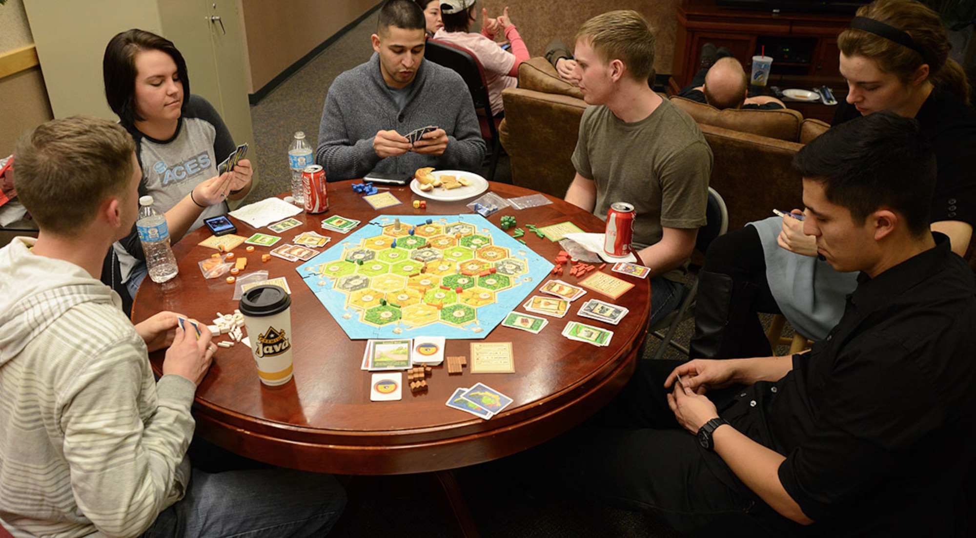 JBER Airmen participate in a board game during a Super Bowl Sunday party hosted by the chapel at the Wired Cafe, Feb. 1. (U.S. Air Force photo/Airman Christopher R. Morales)