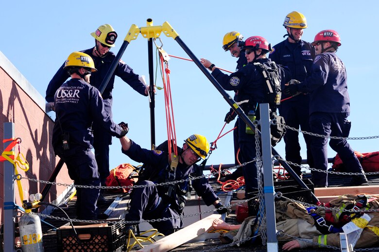 Members of an Urban Search and Rescue regional task force participate in a comprehensive exercise focusing on locating, extracting and stabilizing victims trapped in confined spaces, Feb. 2, 2015, Lompoc, Calif. With multiple stations set-up, firefighters were able to gain important hands-on practice dealing with a variety of different structural failures. (U.S. Air Force photo by Staff Sgt. Jim Araos/Released)
