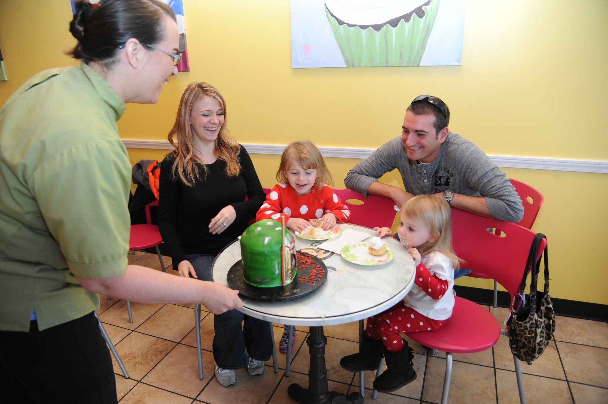 Staff Sgt. Sean Neri, 81st Security Forces Squadron base defense operation center controller and patrolman, Keesler Air Force Base, Miss., receives a birthday cake Jan. 4, 2015, at a local bakery, D’Iberville, Miss. Neri celebrated his return from a six-month deployment to Southwest Asia. (U.S. Air Force photo by Kemberly Groue)