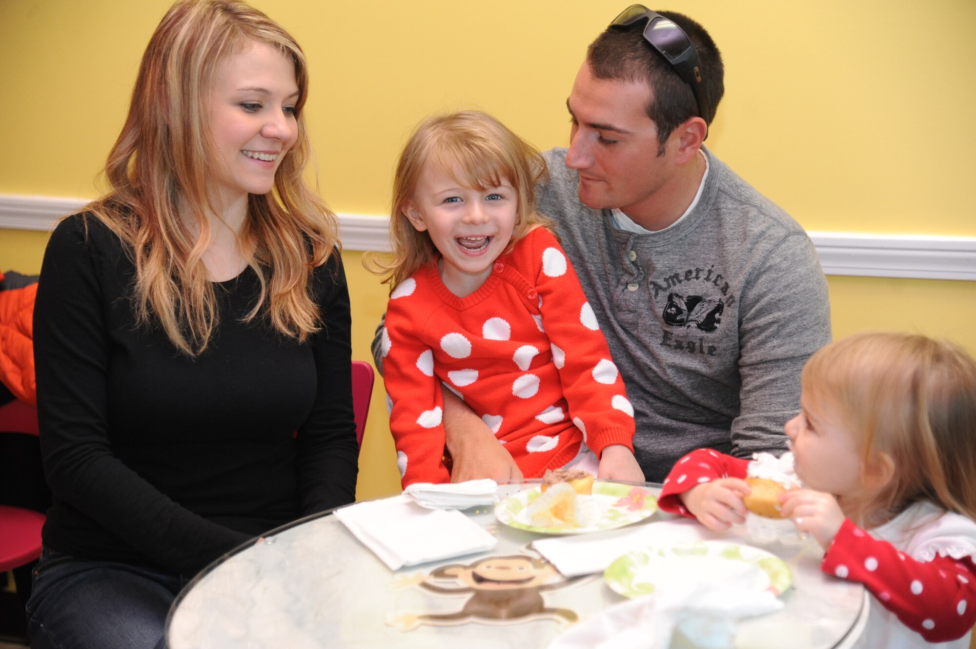 Staff Sgt. Sean Neri, 81st Security Forces Squadron base defense operation center controller and patrolman, surprises his daughters, Izzie and Sophia, as his wife, Ashley, looks on Jan. 4, 2015, at a local bakery, D’Iberville, Miss. Neri returned to Keesler Air Force Base, Miss., Jan. 3 following a six-month deployment to Southwest Asia. (U.S. Air Force photo by Kemberly Groue)