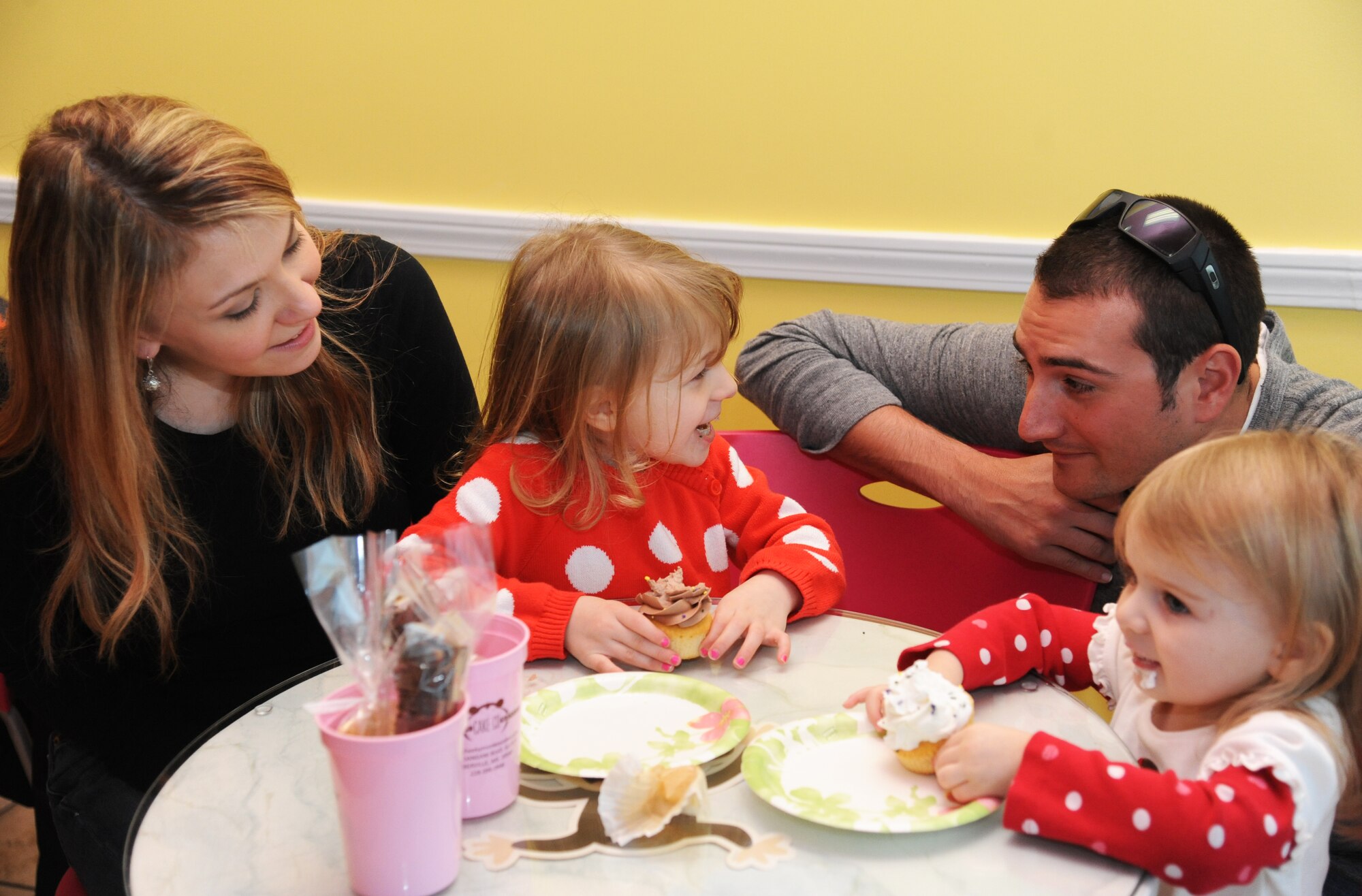 Staff Sgt. Sean Neri, 81st Security Forces Squadron base defense operation center controller and patrolman, surprises his daughters, Izzie and Sophia, as his wife, Ashley, looks on Jan. 4, 2015, at a local bakery, D’Iberville, Miss. Neri returned to Keesler Air Force Base, Miss., Jan. 3 following a six-month deployment to Southwest Asia. (U.S. Air Force photo by Kemberly Groue)